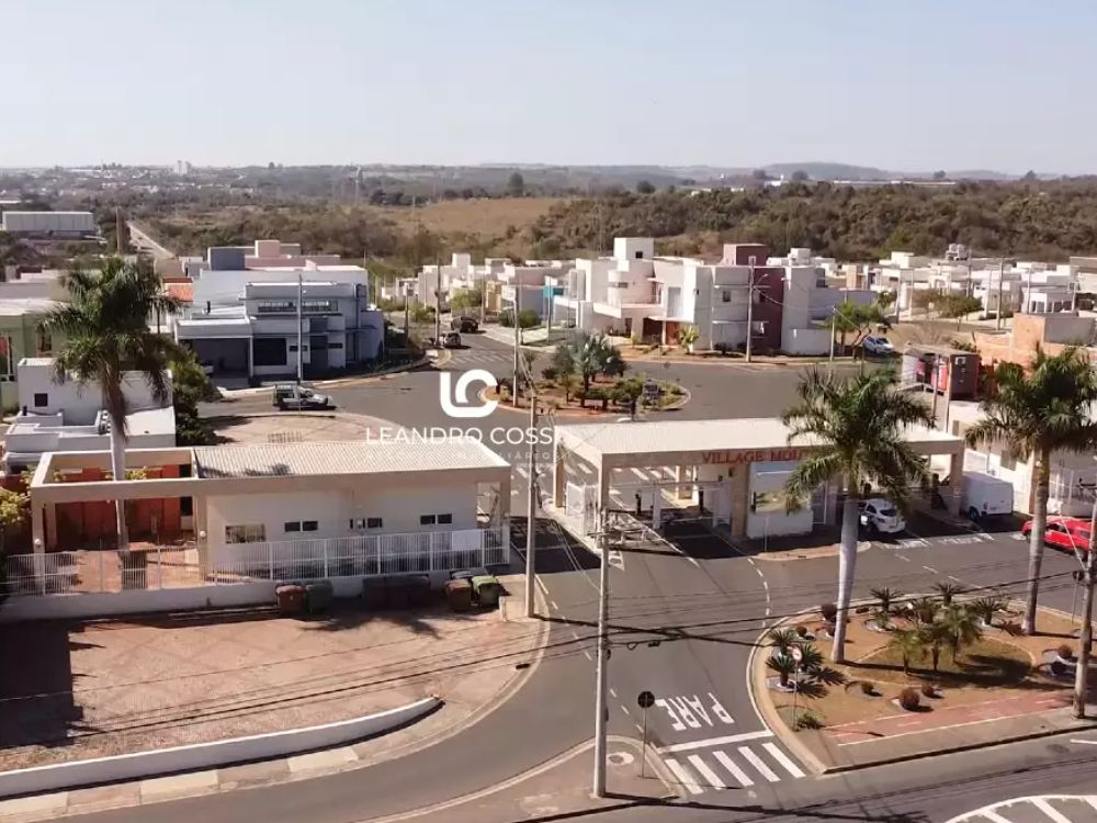 Entrada de condomínio com guarita e ruas organizadas, representando fatores que influenciam quanto custa morar em condomínio fechado